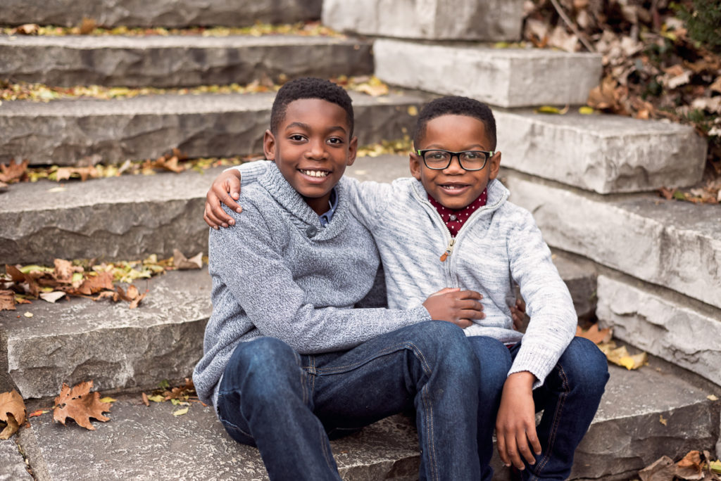 two boys sitting on stone stairs at Gillson Park in Wilmette by family photographer Mila Craila Photography