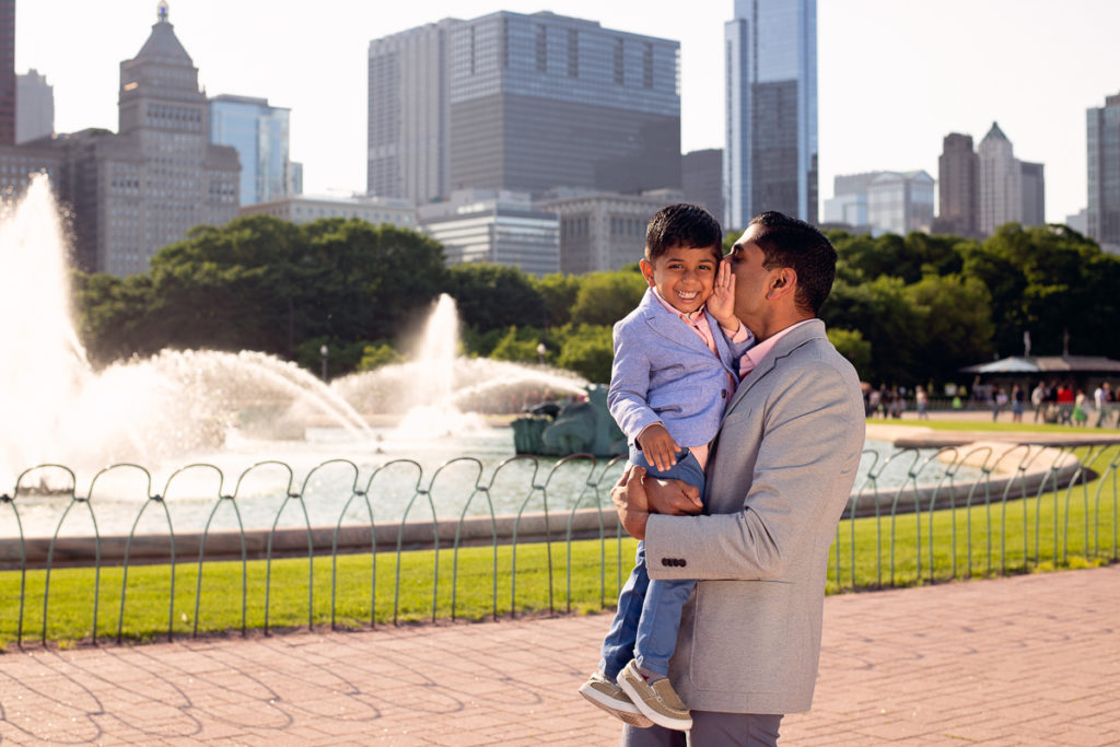 Family session for a dad with a boy at the Buckingham Fountain in Chicago in the summer by family photographer Mila Craila Photography