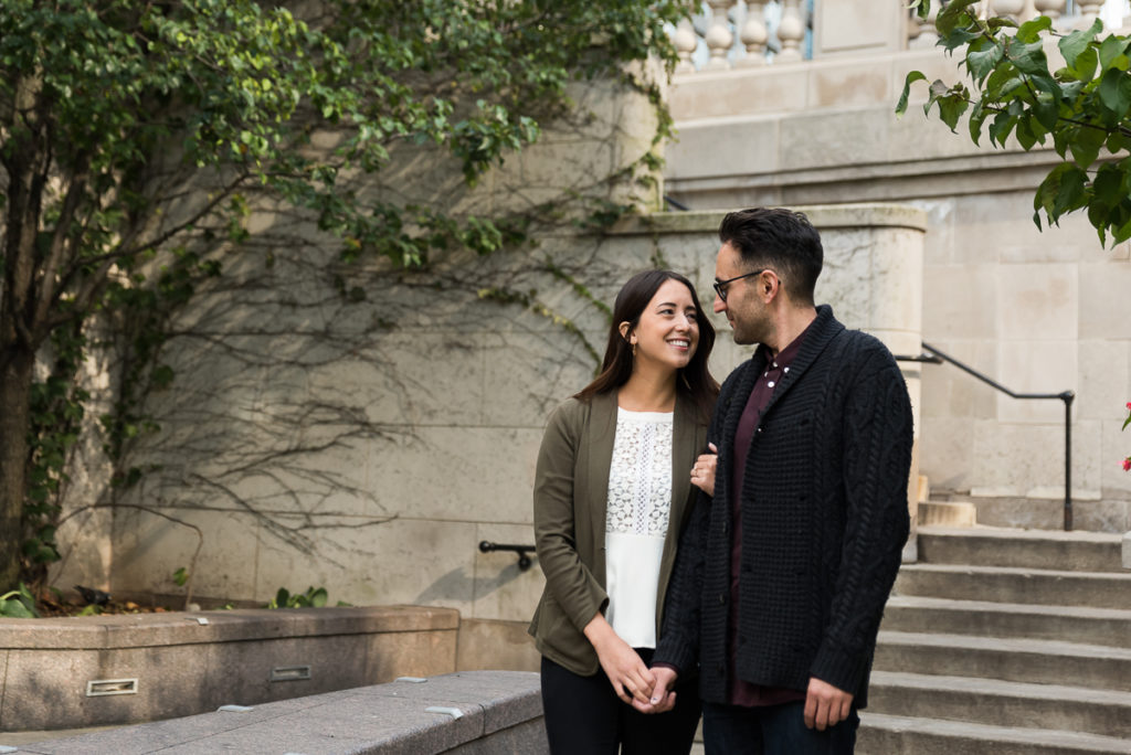 An engagement session for an engaged couple on Riverwalk in downtown Chicago in the fall by a wedding photographer Mila Craila Photography