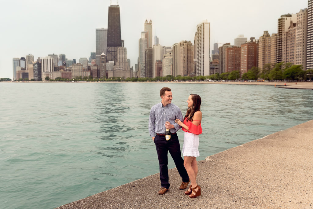 An engagement session for an engaged couple on North Avenue Beach in Chicago in the spring by a wedding photographer Mila Craila Photography