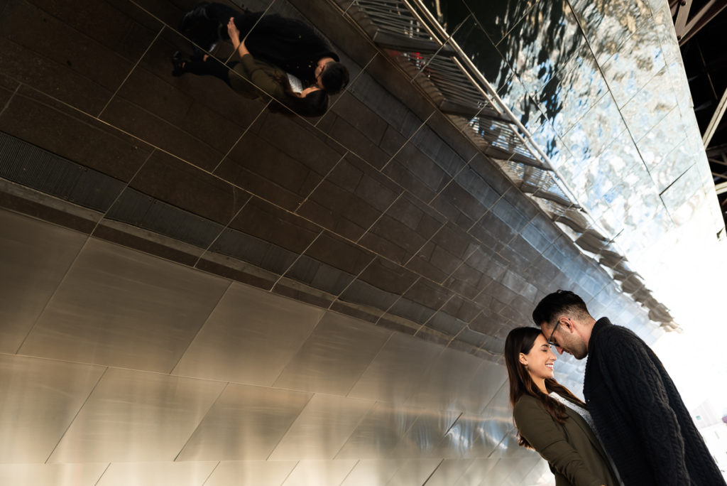 An engagement session for an engaged couple on Riverwalk in downtown Chicago in the fall by a wedding photographer Mila Craila Photography