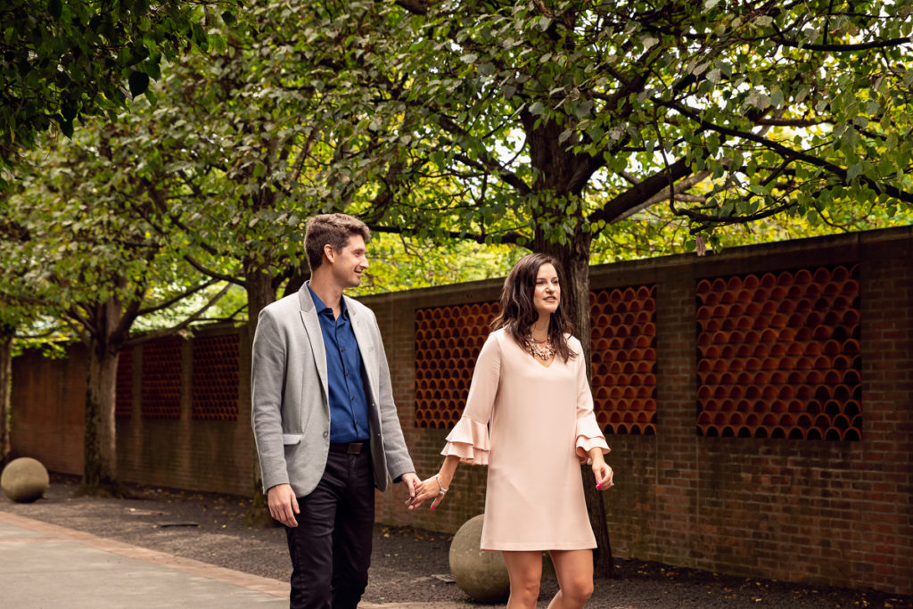 An engagement session for an engaged couple walking at Chicago Botanic Garden in the summer by a wedding photographer Mila Craila Photography