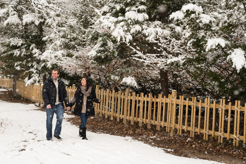 An engagement session for an engaged couple walking at Fabyan Forest Preserve in the winter by a wedding photographer Mila Craila Photography