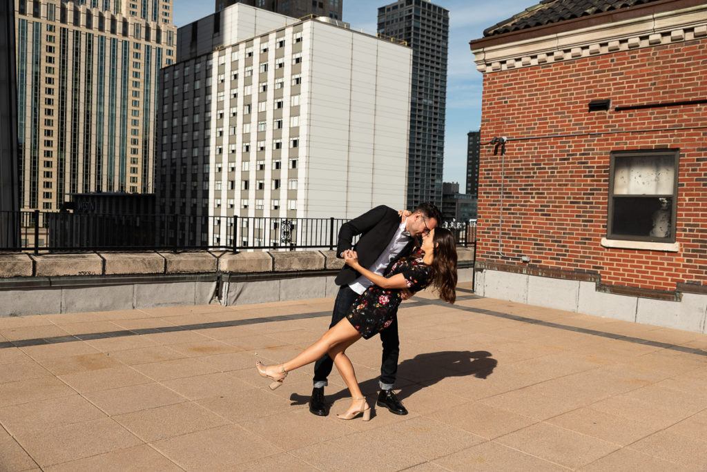 An engagement session for an engaged couple dancing in downtown Chicago in the fall by a wedding photographer Mila Craila Photography