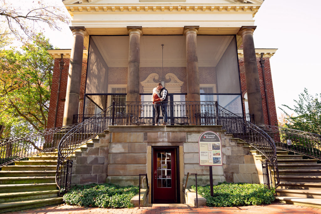 An engagement session for an engaged couple kissing at McCormick House at Cantigny Park in Wheaton in the fall by a wedding photographer Mila Craila Photography