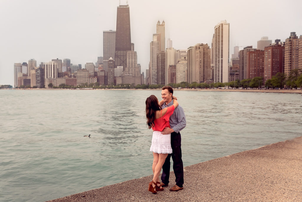 An engagement session for an engaged couple on North Avenue Beach in Chicago in the spring by a wedding photographer Mila Craila Photography