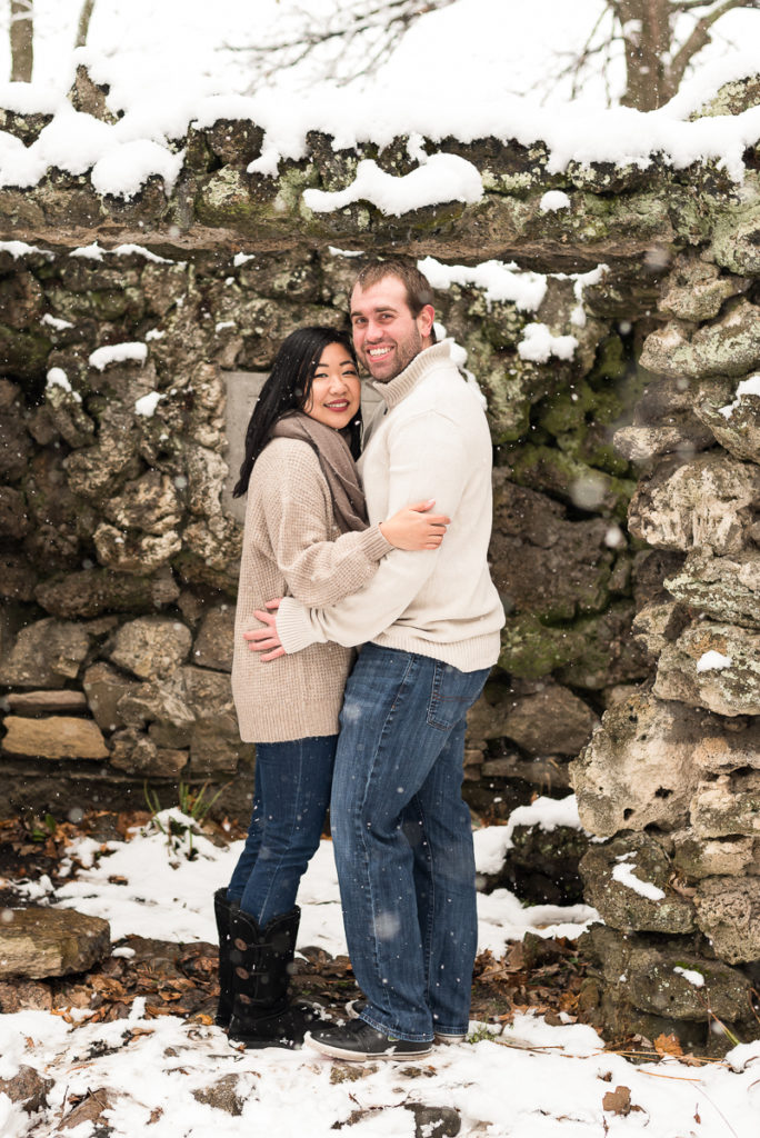 An engagement session for an engaged couple at Fabyan Forest Preserve in the winter by a wedding photographer Mila Craila Photography