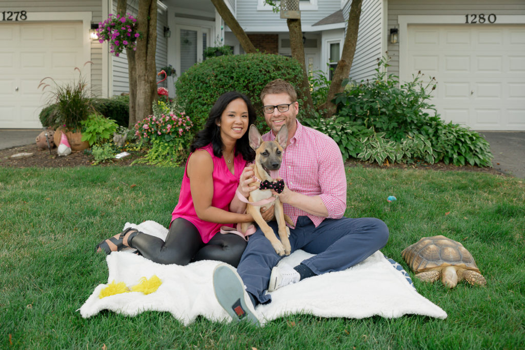 Family session for a couple, a dog and a tortoise in front of their house in Naperville by family photographer Mila Craila Photography