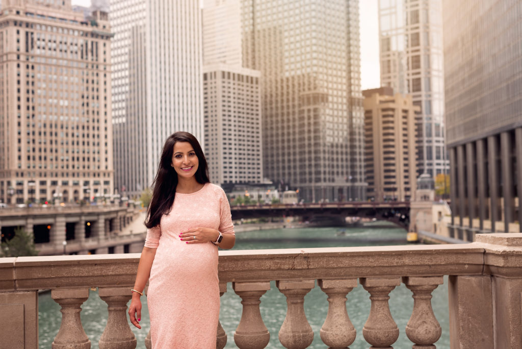 a pregnant woman at the Riverwalk in downtown Chicago by Mila Craila Photography