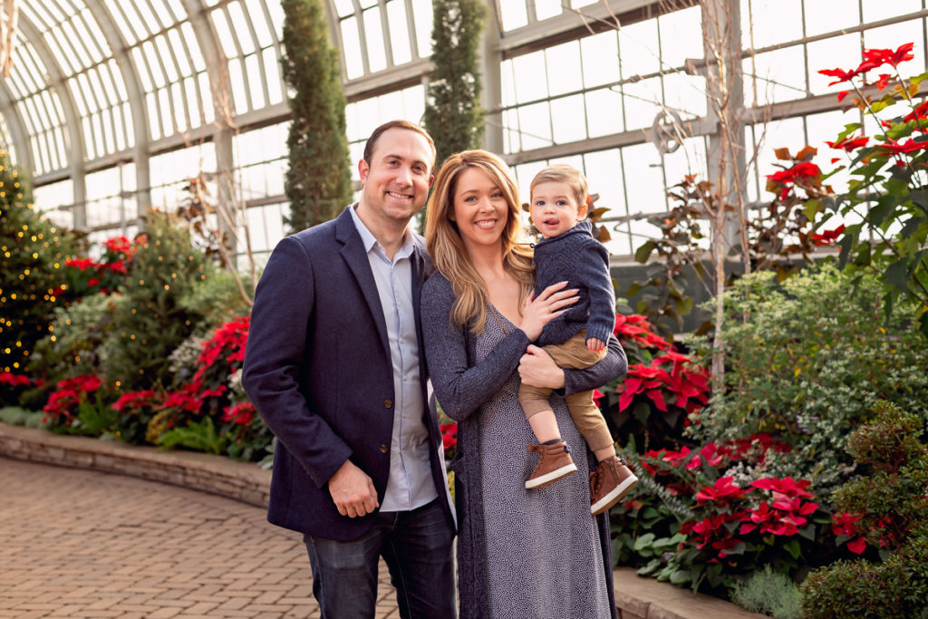 Family session for parents and a toddler son at Garfield Park Conservatory in Chicago on Christmas by family photographer Mila Craila Photography