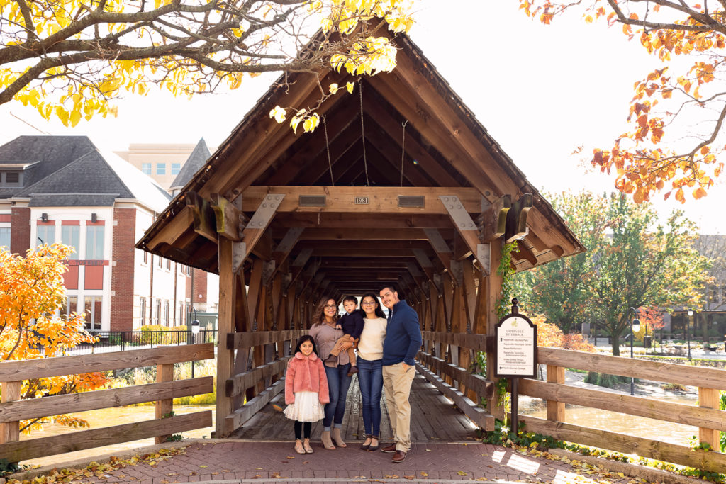 Family session for a family with three kids on the bridge on Naperville Riverwalk by family photographer Mila Craila Photography