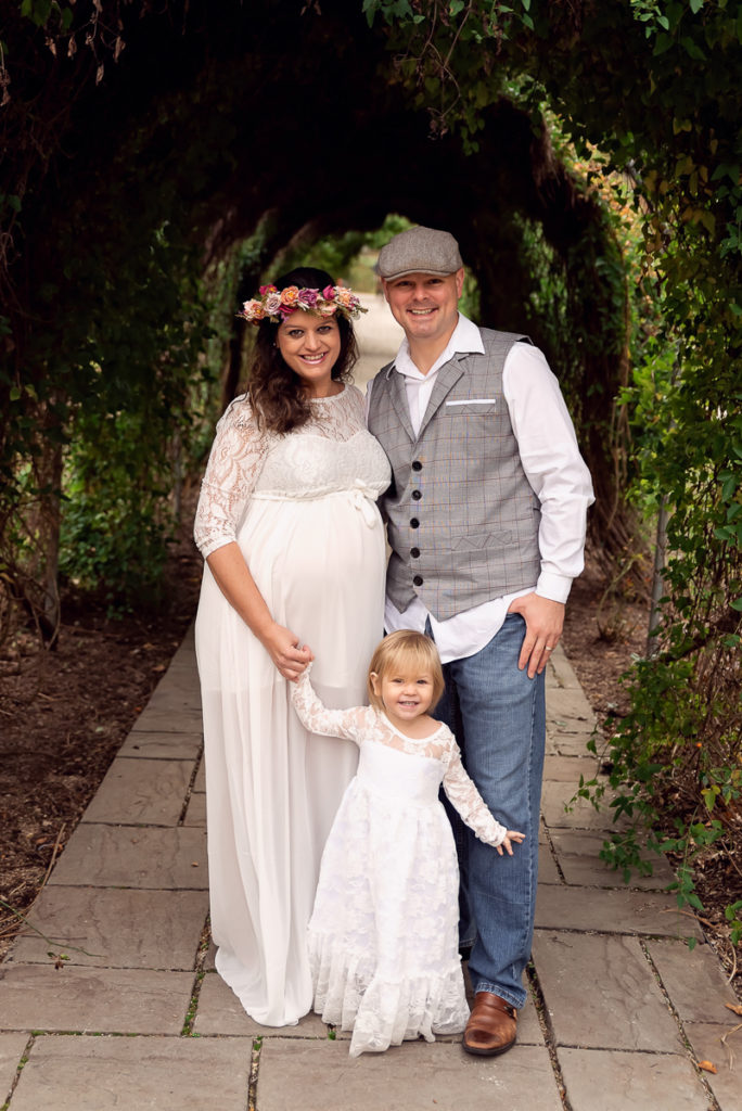 Family session for pregnant parents and a toddler daughter at Fabyan Forest Preserve in Geneva by family photographer Mila Craila Photography