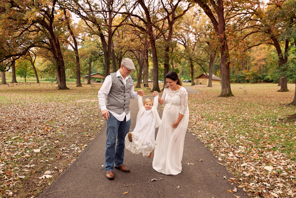 Family session for pregnant parents and a toddler daughter at Fabyan Forest Preserve in Geneva by family photographer Mila Craila Photography