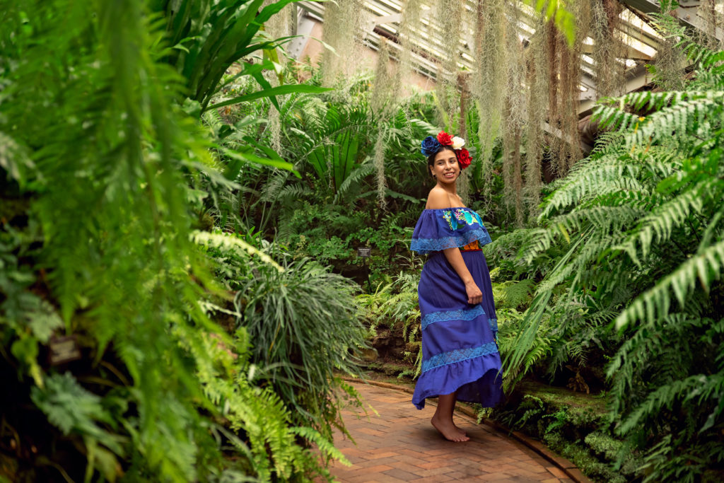 A maternity session for a pregnant woman in a traditional Mexican dress in Garfield Park Conservatory by a maternity photographer Mila Craila Photography