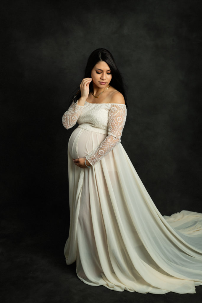 a pregnant woman in a photography studio by Mila Craila Photography